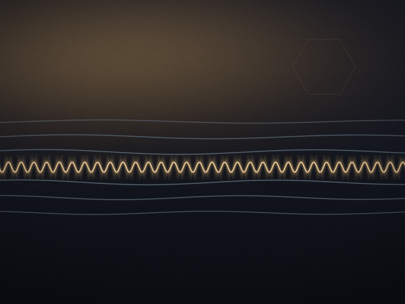 A single glowing amber wave line with many quick, even ripples across a dark slate background, with fainter slow blue waves around it and a warm lamp glow in the upper left.